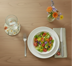 Round ceramic plate with floral design on a white background