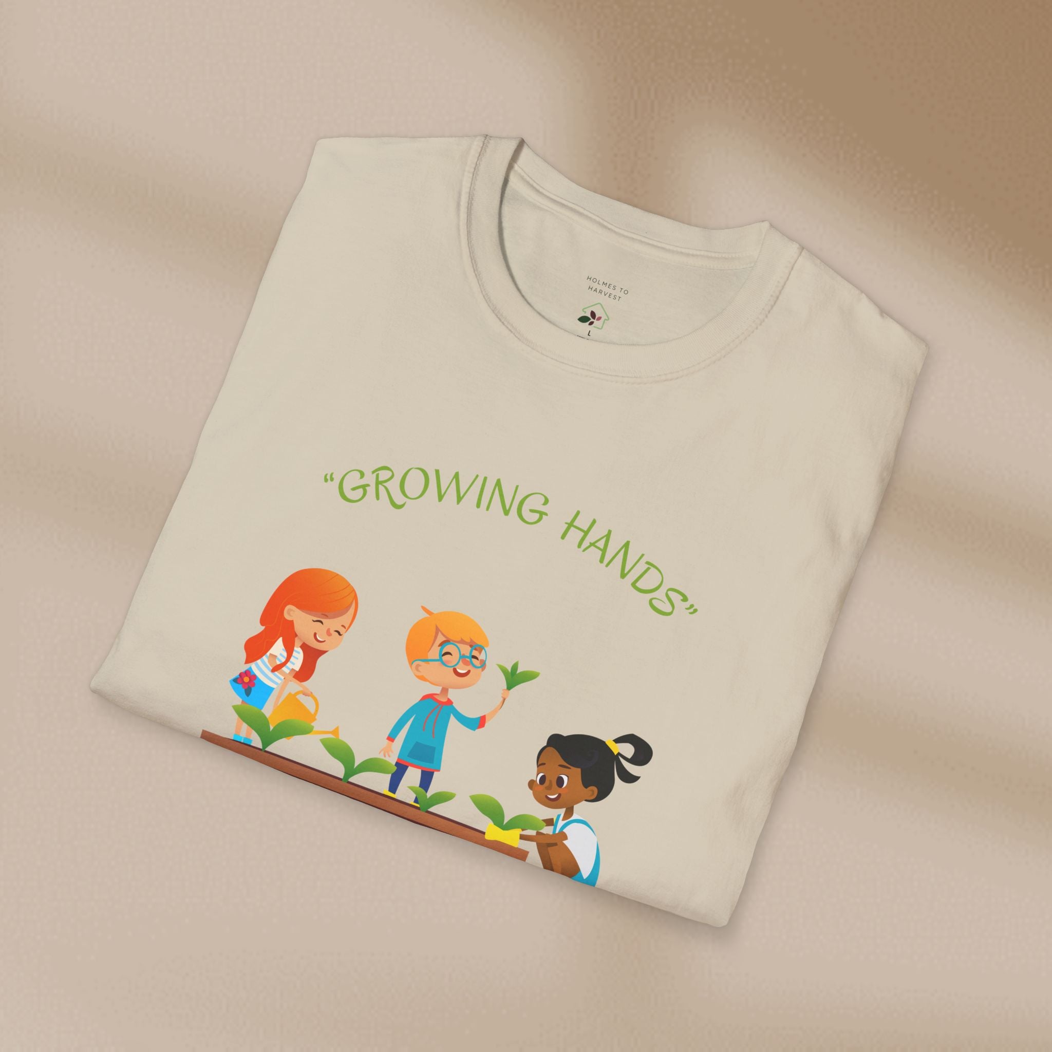 Folded t-shirt with 'Growing Hands' design on a beige background