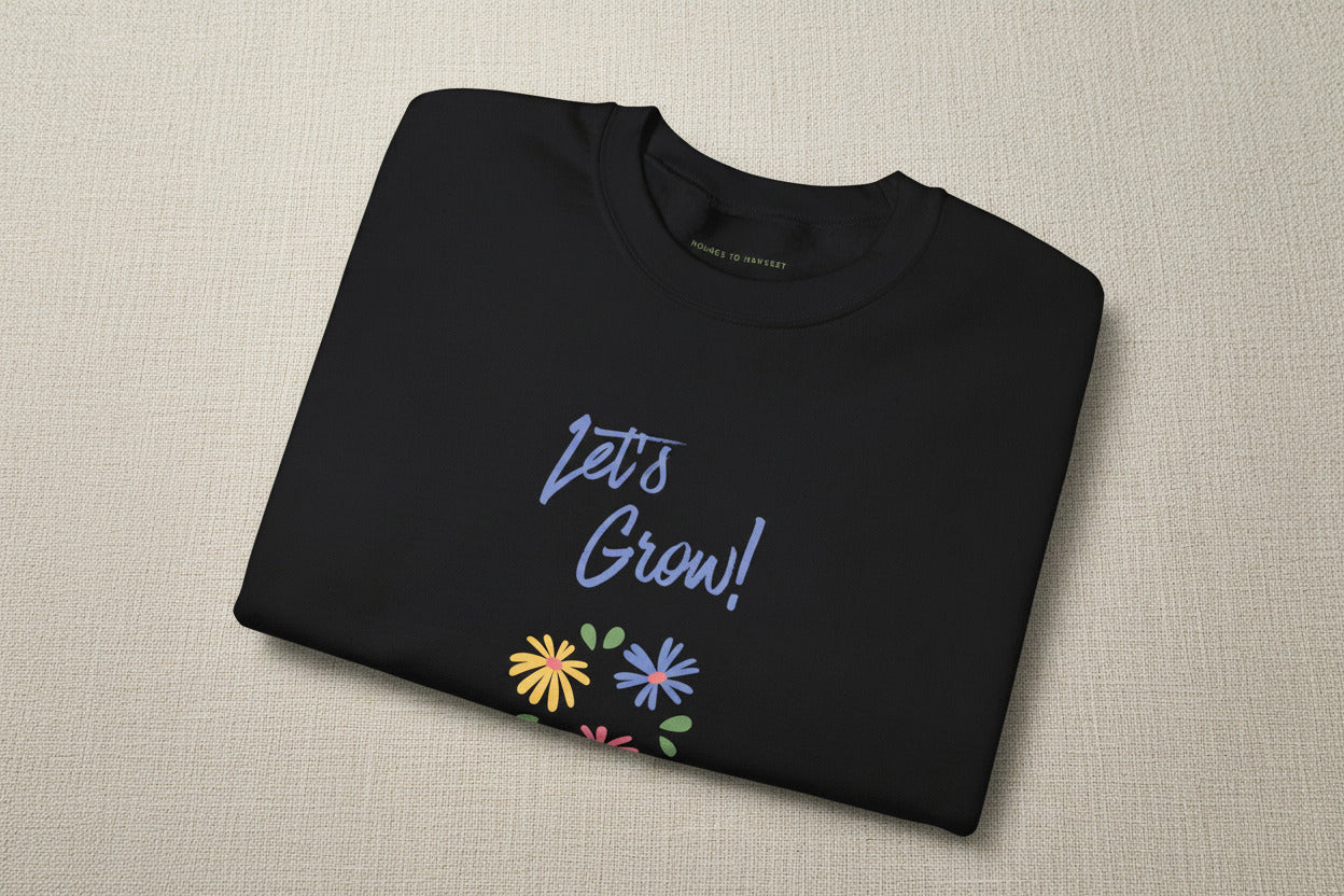 Folded green sweatshirt with a cat wizard graphic and 'GEEK' branding.