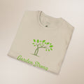 Beige t-shirt with green tree and 'Garden Strong' text on a beige background