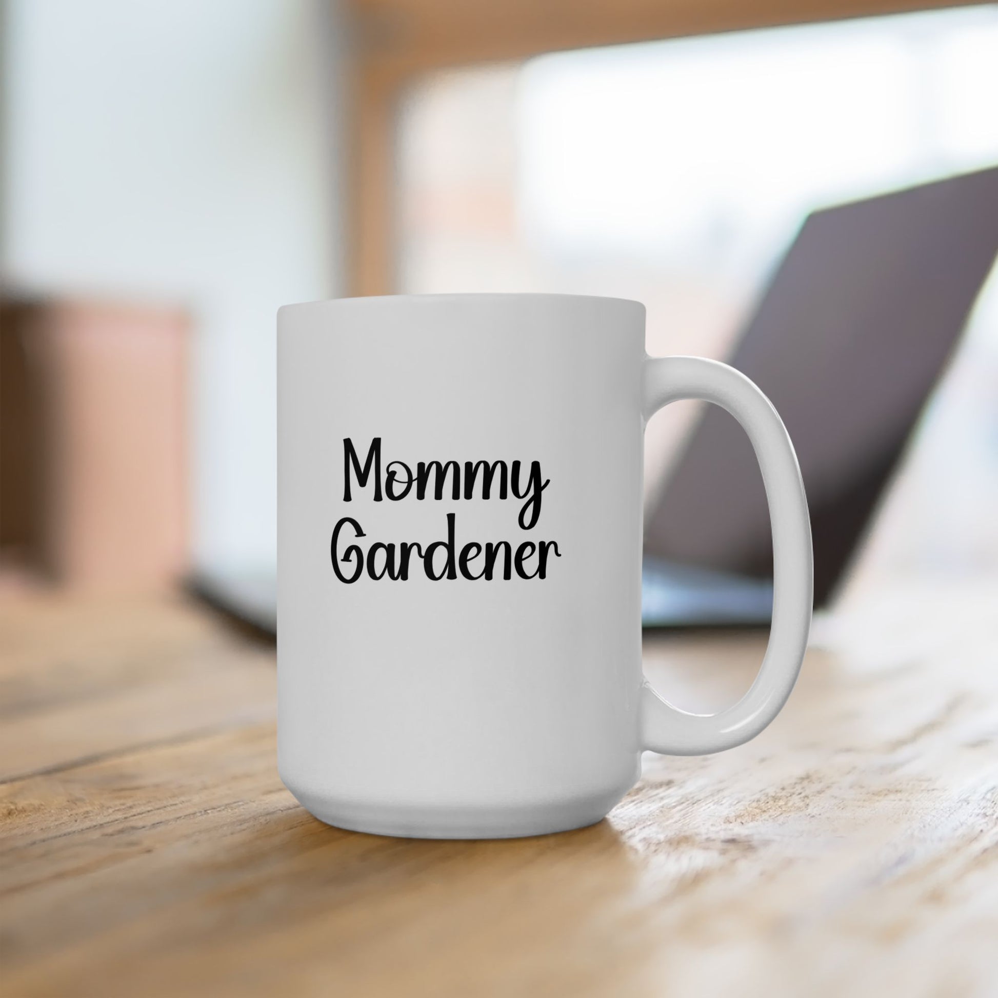 White mug with 'Mommy Gardener' text on a wooden surface