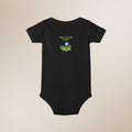 Black baby onesie with 'New to the Patch' design on a beige background