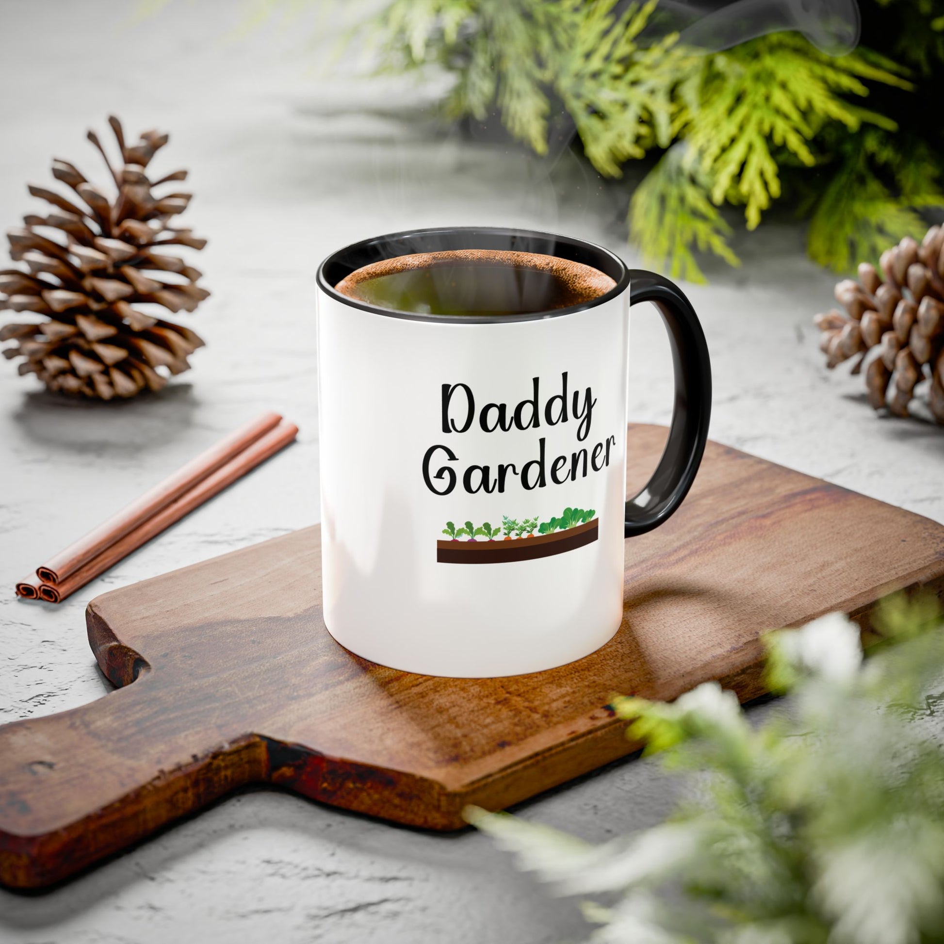 Mug with 'Daddy Gardener' text on a wooden board with pinecones and cinnamon sticks.