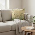 Decorative pillow with nature-themed design featuring butterflies and plants on a beige background.