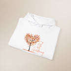 White hoodie with a tree and text design on a beige background