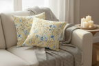 Decorative pillows with floral pattern on a beige sofa in a living room setting.