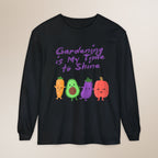 Black long-sleeve shirt with cartoon vegetables and text on a beige background