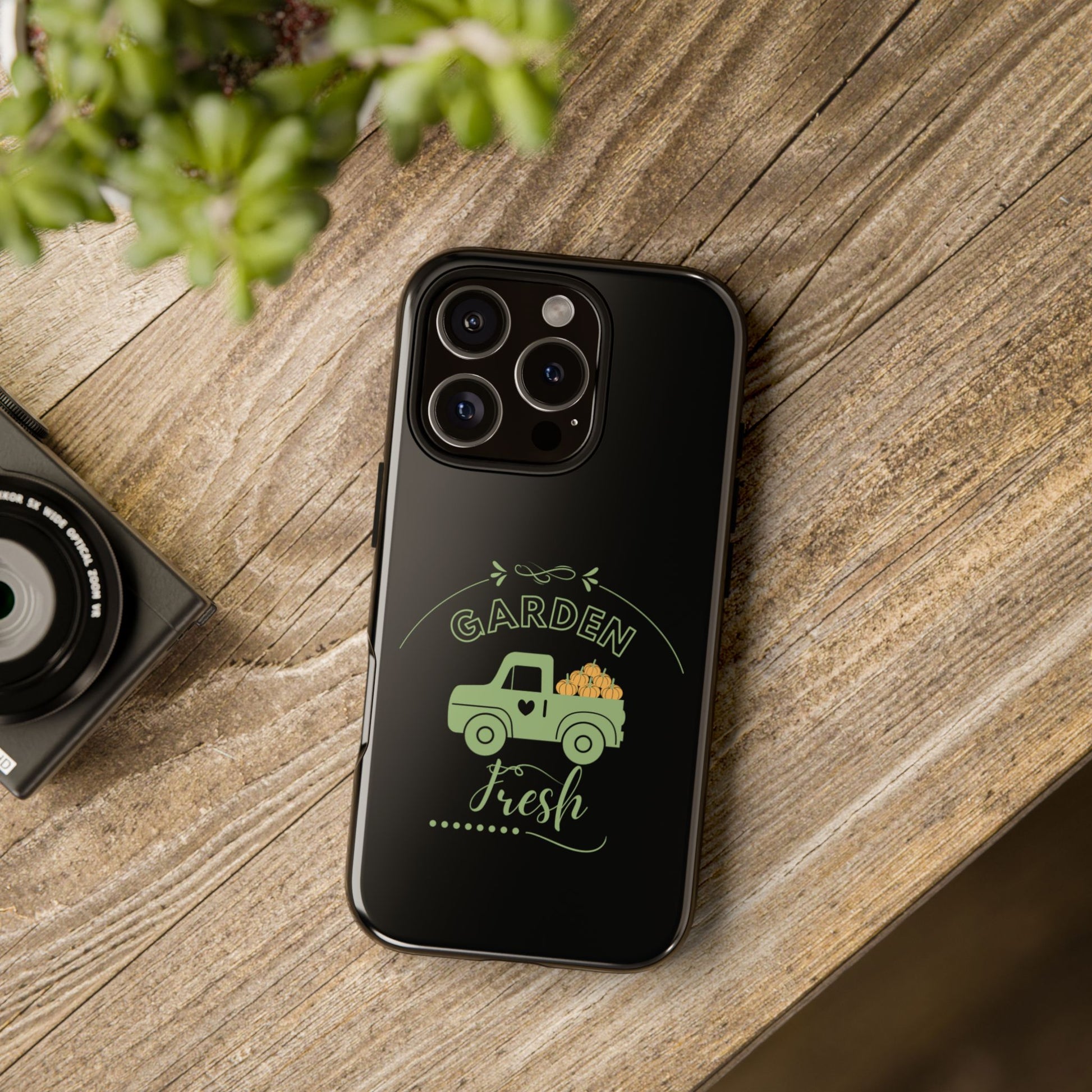 Phone case with 'Garden Fresh' design on a wooden surface
