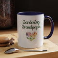 Mug with 'Gardening Grandpapa' text and heart design on a wooden surface with coffee beans and a spoon.