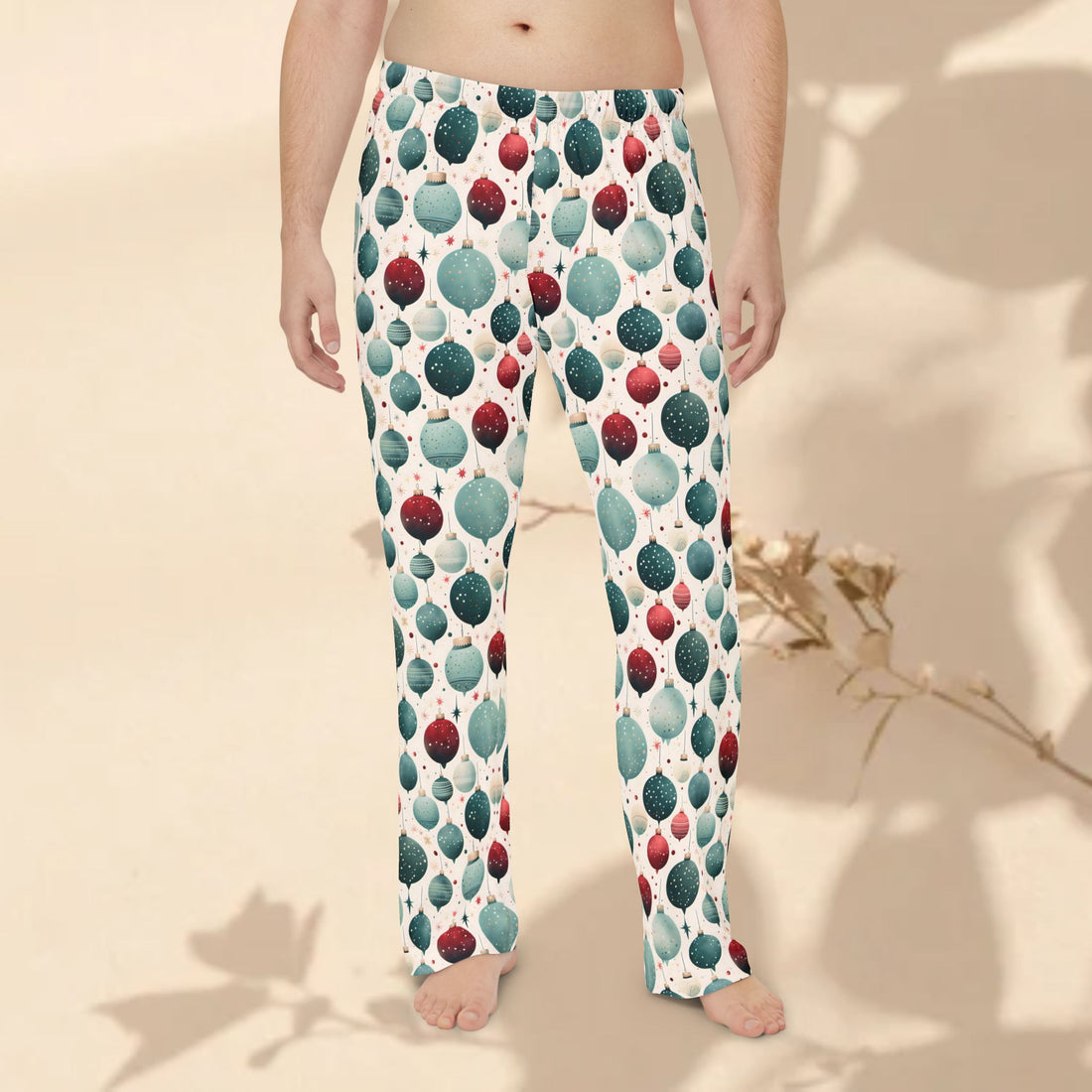 Man in a kitchen wearing patterned pajama pants holding a plate with food.