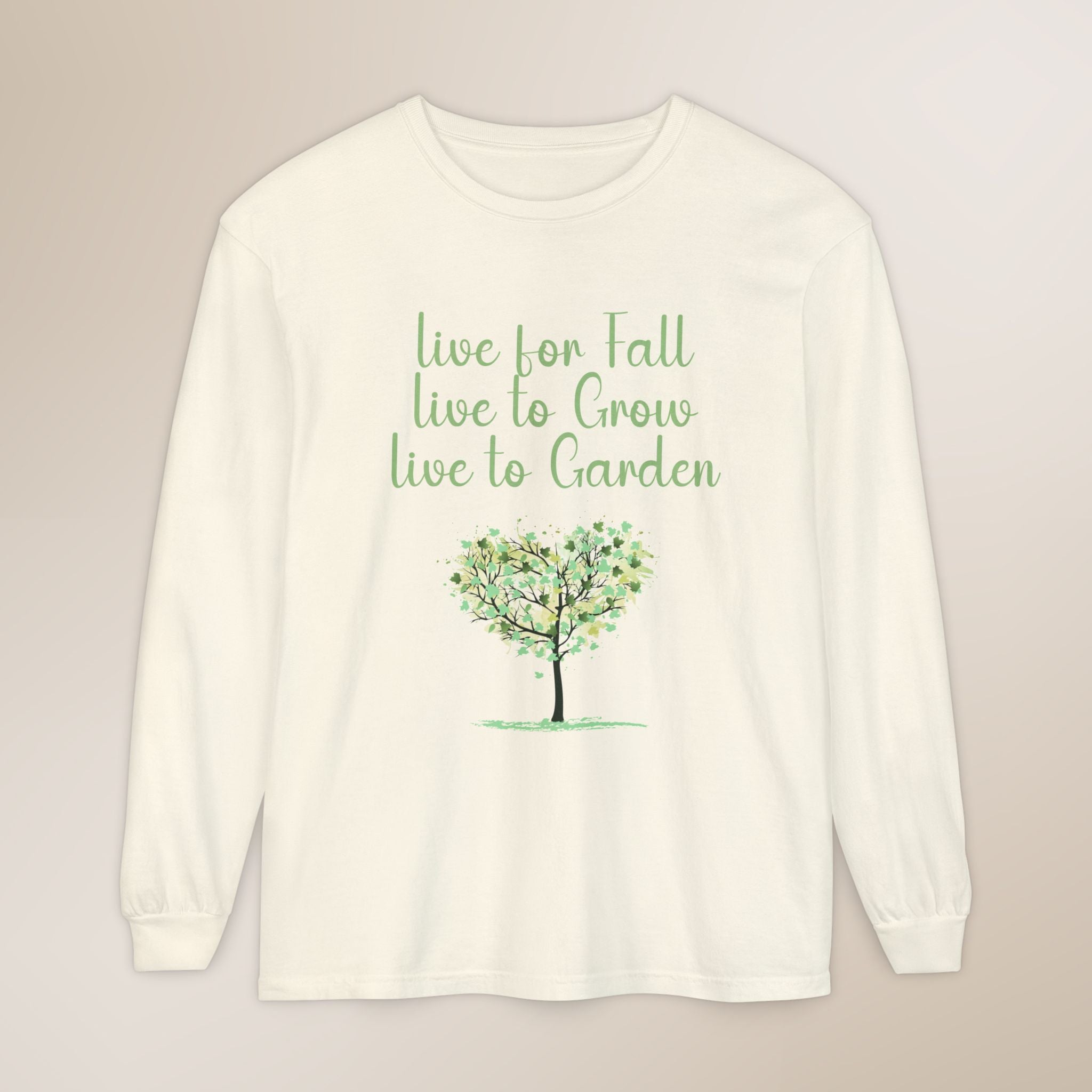 White long-sleeve shirt with green text and tree graphic on a beige background