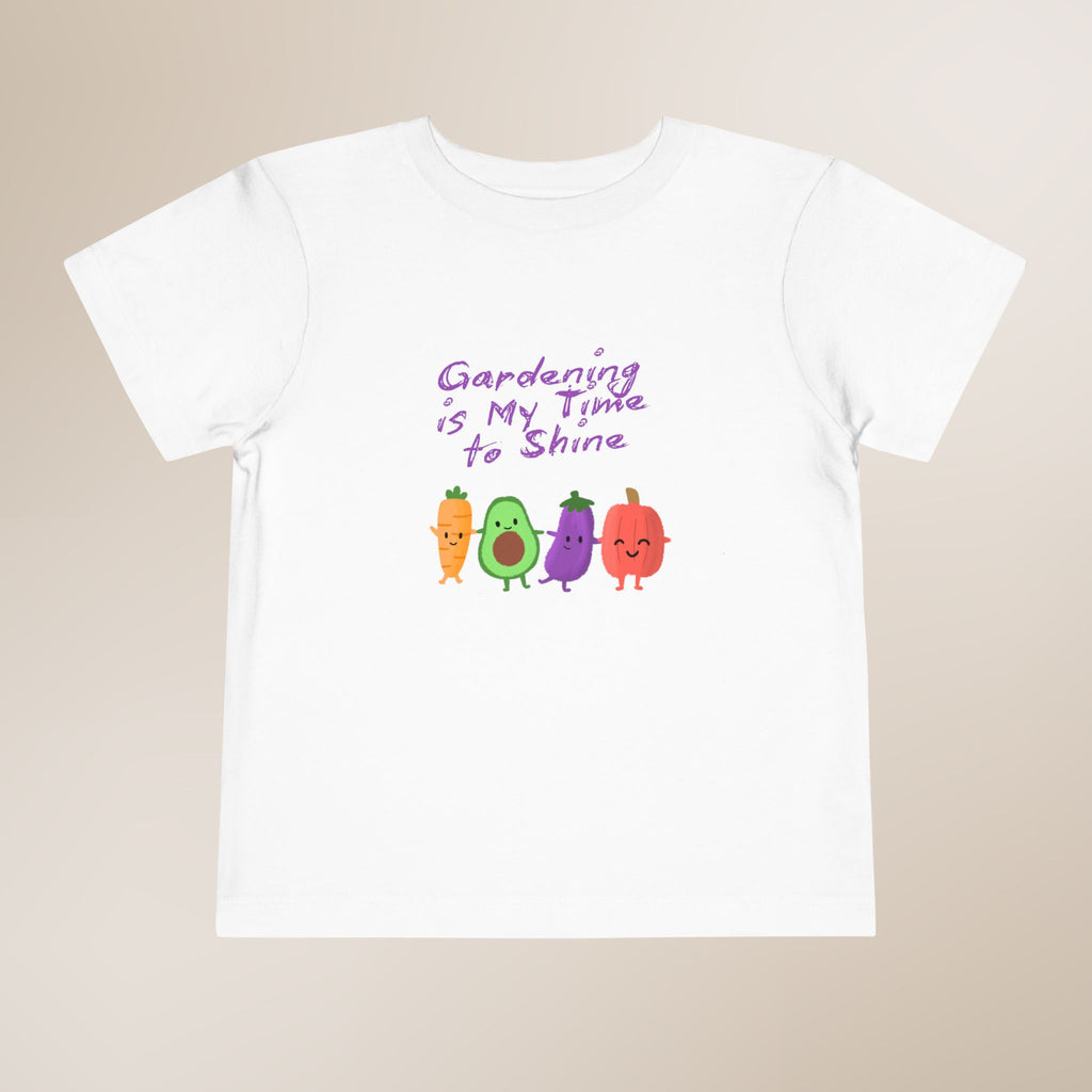 White t-shirt with colorful vegetable graphics and text on a beige background