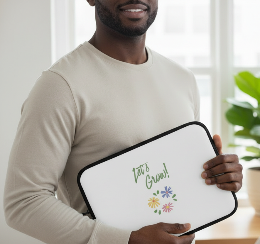 Man holding a white laptop sleeve with 'Let's Grow!' text and floral design.