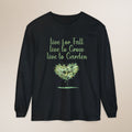 Black long-sleeve shirt with green text and tree graphic on a beige background