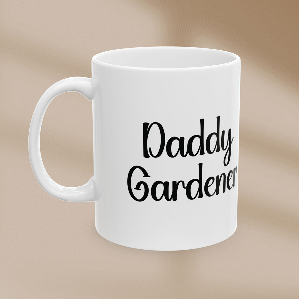 White mug with 'Daddy Gardener' text on a beige background