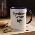 Mug with 'Grandmama Gardener' text and leaf design on a wooden surface with coffee beans and a spoon.