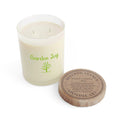 Candle labeled 'Garden Joy' with a wooden lid on a white background