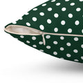 Green pillow with white polka dots on a white background