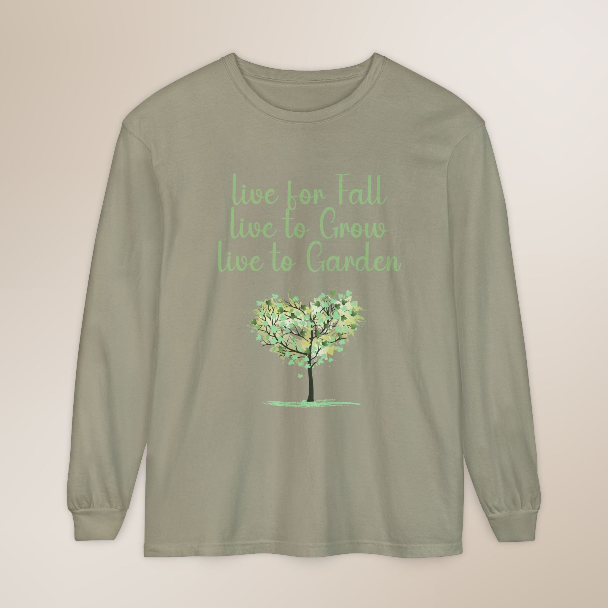 Sage green long-sleeve shirt with a tree graphic and text on a beige background