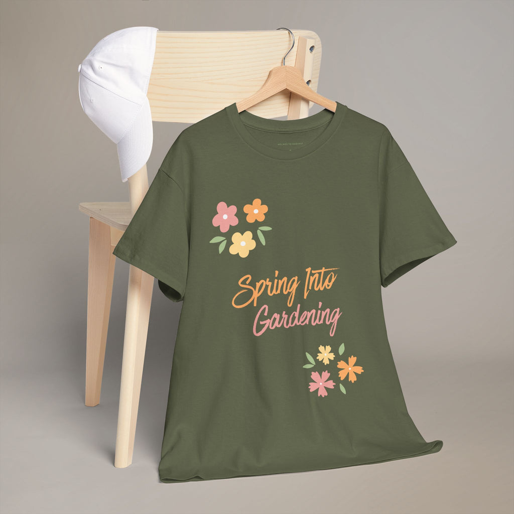 Green t-shirt with 'Spring Into Gardening' text and flowers on a hanger against a gray background