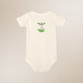 White baby onesie with 'New to the Patch' text and floral design on a beige background