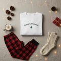 White long-sleeve shirt with 'Merry Christmas' and a tree design on a beige background