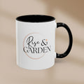 White mug with black interior and handle featuring 'Rise & Garden' text on a beige background
