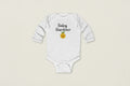 White baby onesie with 'Baby Gardener' text and emoji on a white background