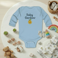 Light blue baby onesie with 'Baby Gardener' text and emoji on a white background