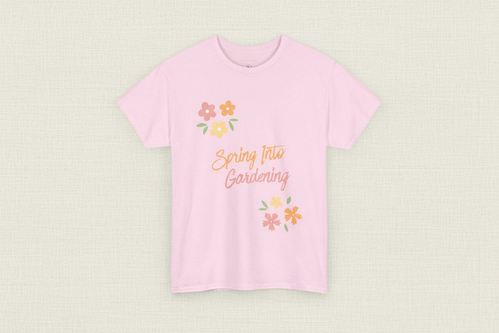 Pink t-shirt with 'Spring Into Gardening' text and floral designs on a white background