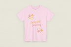 Pink t-shirt with 'Spring Into Gardening' text and floral designs on a white background