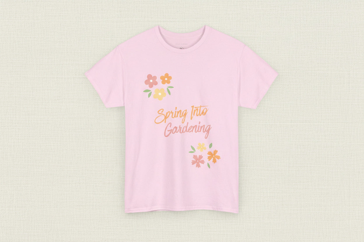 Pink t-shirt with 'Spring Into Gardening' text and floral designs on a white background