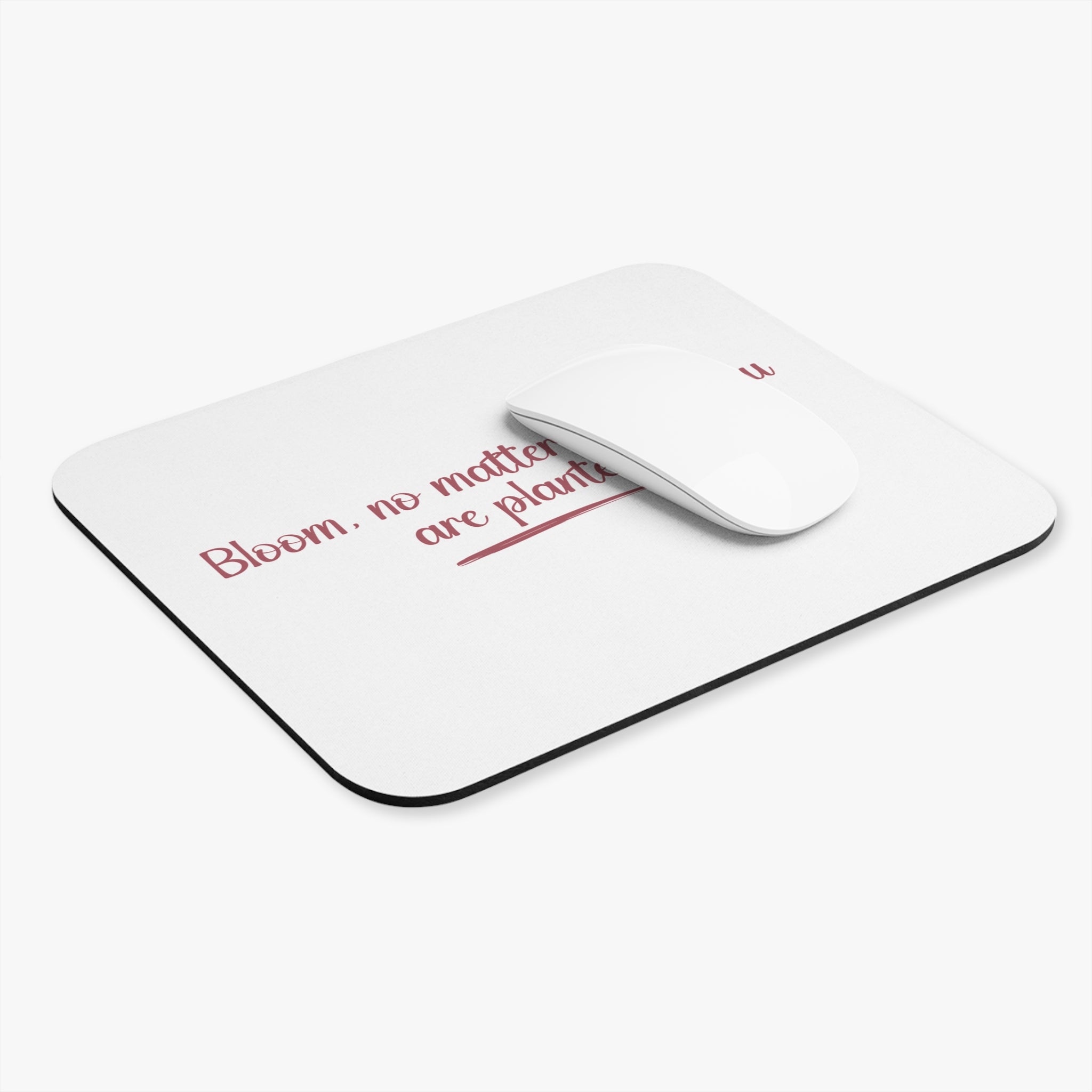 White mouse pad with red text and a white mouse on a white background