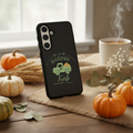 Phone case with 'Garden Fresh' design on a table with pumpkins and coffee.