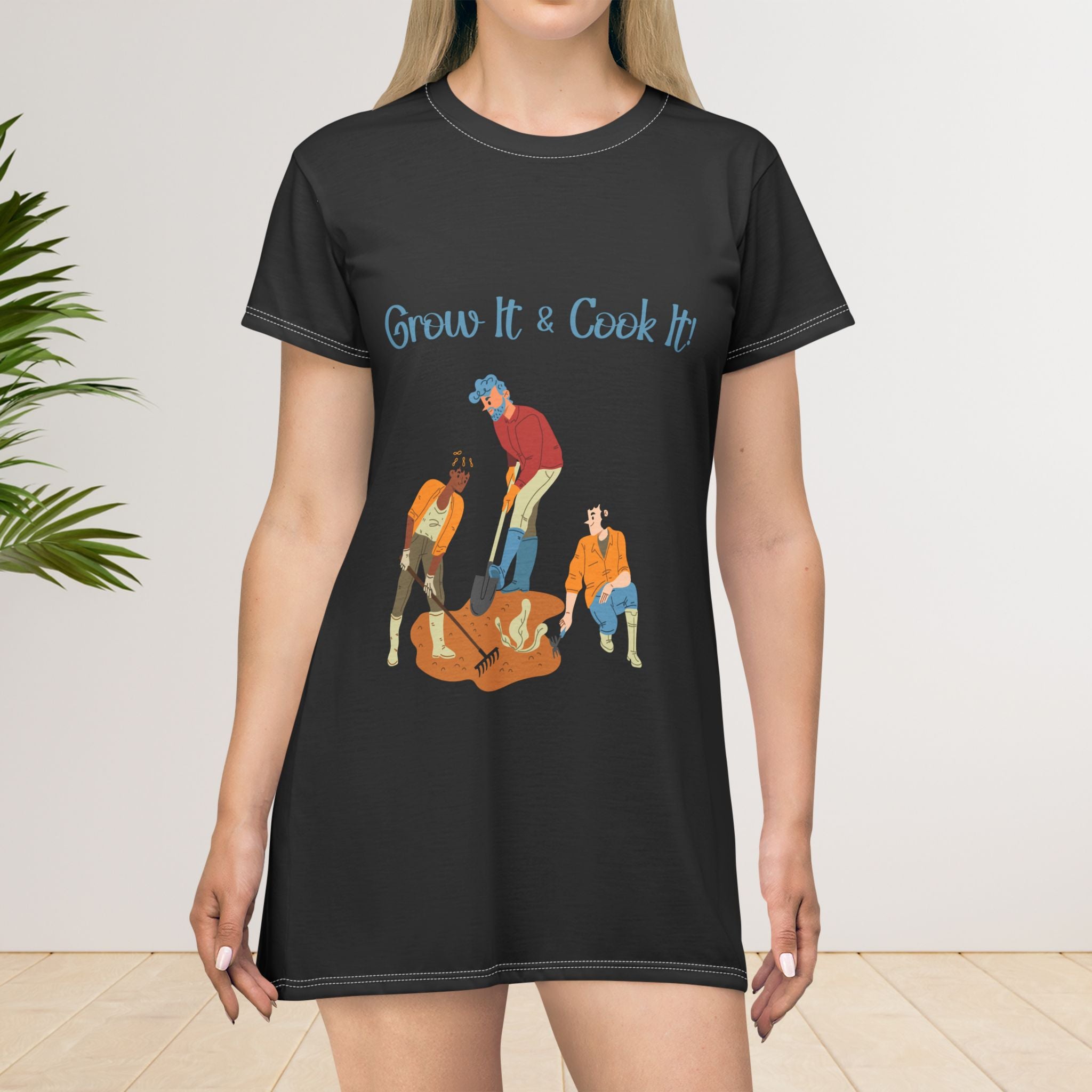 Black t-shirt dress with 'Grow It & Cook It' text and graphic of people gardening, worn by a model.