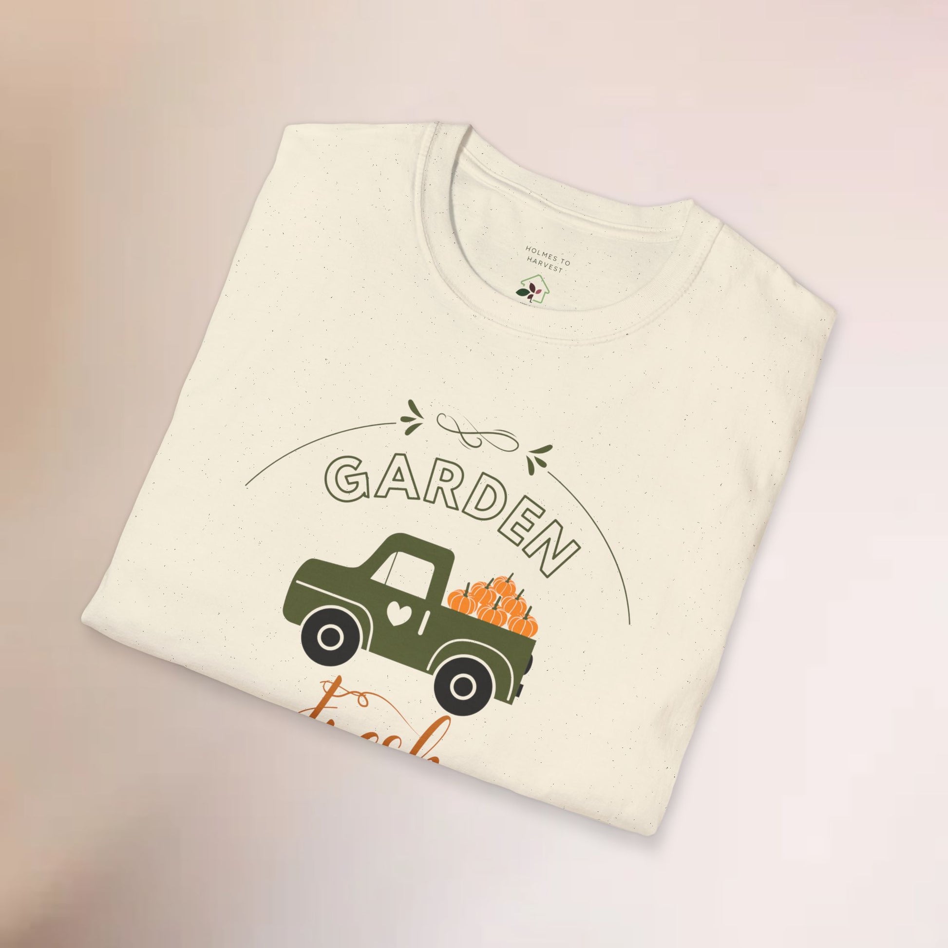Folded t-shirt with a graphic of a truck and 'Garden' text on a light background