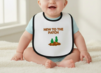 Baby wearing a bib with 'New to the Patch' text and cactus graphics on a white background