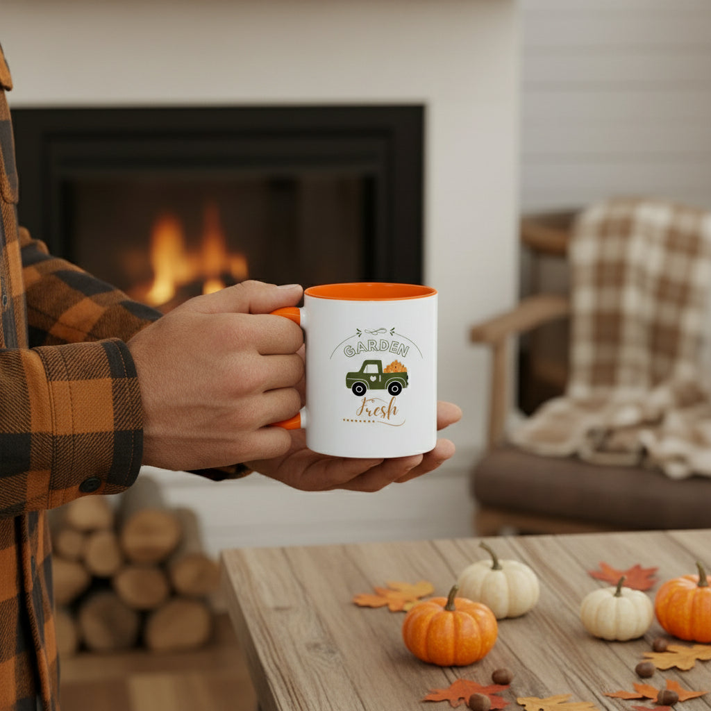 White mug with orange interior and handle featuring a green truck and 'Garden Fresh' text on a beige background.