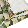 Roll of green leaf-patterned fabric on a white background
