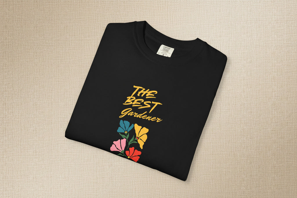 Black t-shirt with 'The Best Gardener' text and colorful flowers on a beige background