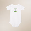 White baby onesie with 'New to the Patch' text and graphic on a beige background