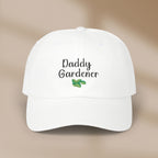 White cap with 'Daddy Gardener' text and leaf design on a beige background