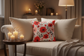 Cozy living room with a beige sofa, floral pillow, and candles on a side table.