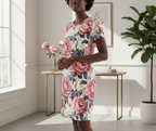 Woman wearing a floral dress standing in a bright room with a plant and table.