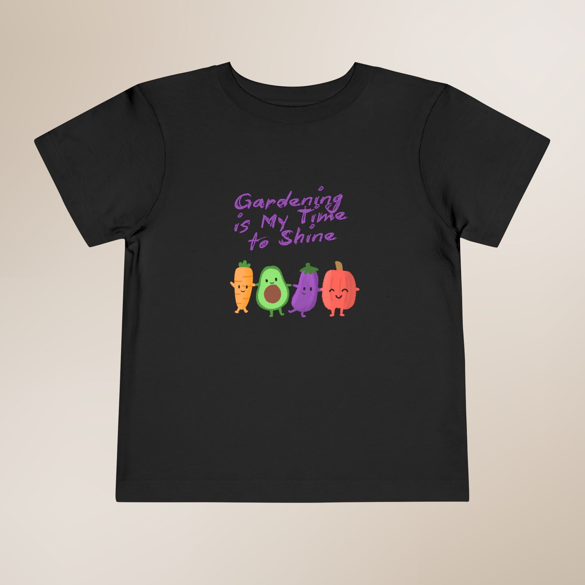 Black t-shirt with colorful vegetables and text on a beige background