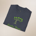 Folded navy blue t-shirt with green tree and 'Garden Strong' text on a beige background