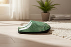 Pair of green slippers with floral pattern on a white background