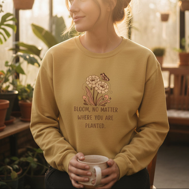 Mustard yellow long-sleeve shirt with floral design and text on a beige background