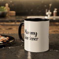 White mug with black interior and handle, featuring 'Mommy Gardener' text, on a kitchen counter.