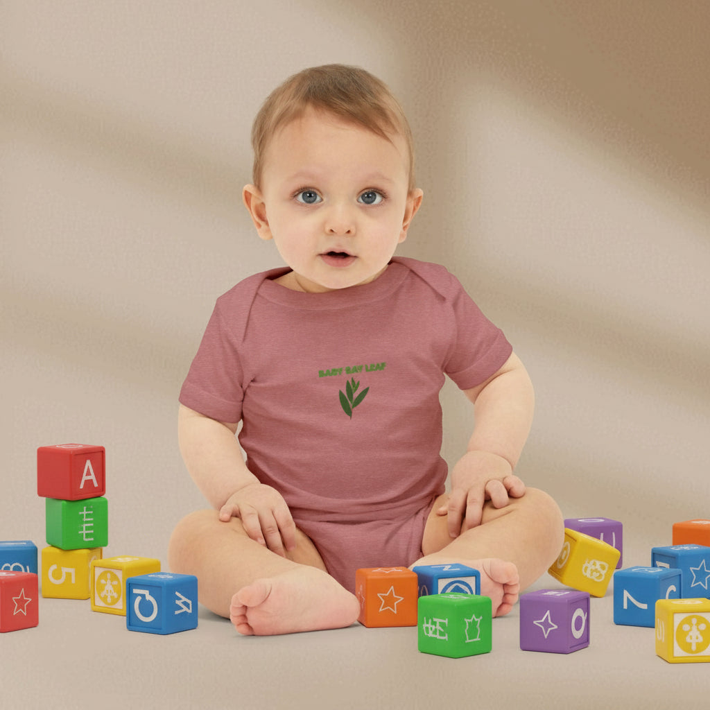 Baby wearing a pink onesie with a green logo on a beige background